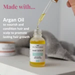 Nourishing Hair Serum Duo for smooth, shiny, and healthy-looking hair. Opened Serum displayed on table with wash towel focusing on dropper applicator.