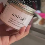 Nourishing body cream infused with wild yam and antioxidants for deep hydration and healthy, radiant skin. Extended hand displaying container.