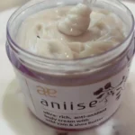 Nourishing body cream infused with wild yam and antioxidants for deep hydration and healthy, radiant skin. Displayed opened on table showing creamy rich texture.