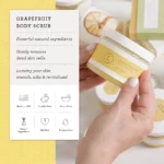 Extended had holding jar of Grapefruit Bod Scrub, in front of indiscrete background. A list of benefits and info regarding the product are listed on the side.