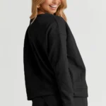 Back view of Adalyn loungewear set featuring a textured long sleeve top and matching drawstring shorts, cozy and stylish two-piece lounge outfit for women.