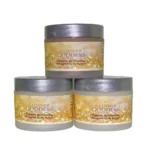 Organic shimmering whipped body butter trio in three jars, displayed on a wooden surface with natural ingredients like shea butter and coconut oil, perfect for deep hydration and glowing skin. Displayed in front of a white background.