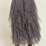 Back view of stylish layered polka dot mesh lined midi skirt for women, flowy and elegant, perfect for casual or party wear.