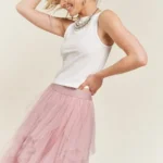 Model showing side view of stylish layered polka dot mesh lined midi skirt for women, flowy and elegant, perfect for casual or party wear.