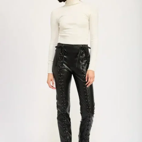 Model wearing edgy lace-up leather trousers with high-waist design and front lace-up detailing, styled for a sleek, modern, and fashion-forward look.