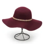 Stylish wool felt fashion floppy hat for women – timeless wide brim design. Displayed on a wire hat stand.
