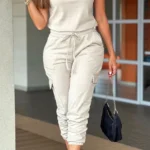 Front view of crew neck short sleeve jumpsuit with drawstring waist, lightweight summer one-piece outfit for women.