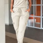 Front view of crew neck short sleeve jumpsuit with drawstring waist, lightweight summer one-piece outfit for women.