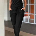Front view of crew neck short sleeve jumpsuit with drawstring waist, lightweight summer one-piece outfit for women.