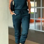 Front view of crew neck short sleeve jumpsuit with drawstring waist, lightweight summer one-piece outfit for women.