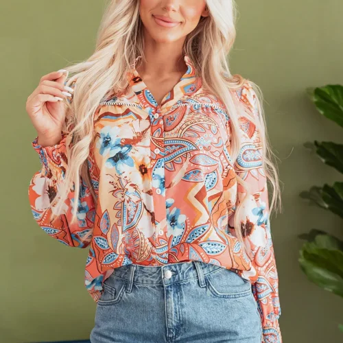 Front view of the Leighton Floral Button Loose Shirt displayed neatly, showcasing the vibrant floral print, button details, and relaxed loose fit design.