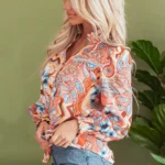 Side view of the Leighton Floral Button Loose Shirt, highlighting the relaxed fit, flowy silhouette, and beautiful floral print design along the sleeve and body.