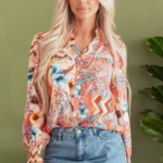 Front view of the Leighton Floral Button Loose Shirt displayed neatly, showcasing the vibrant floral print, button details, and relaxed loose fit design.