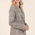 Side angle of plaid double-breasted blazer highlighting structure and plaid pattern