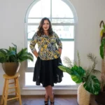 Model wearing knee-length circle skirt with side pocket styled with tucked blouse for classic everyday look — BeautyPlusFashion.