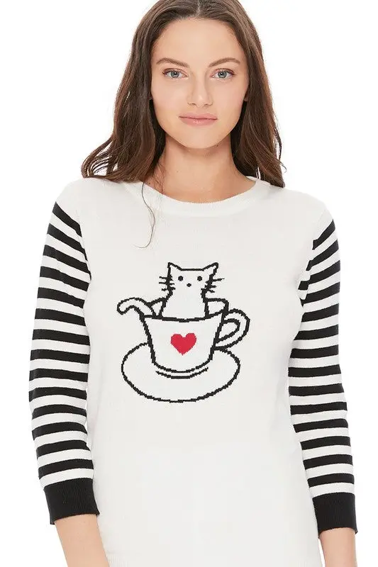 Front view of women’s jacquard sweater featuring adorable cat in cup design