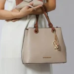 Model holding MKF Kearny Women’s Wallet with matching Tote Handbag draped over arm — stylish MKF Collection designer bag and wallet set for women