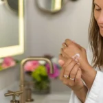 Woman applying lavender shea butter body cream to hands for smooth hydrated skin