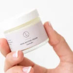 Close up of container with lavender shea butter moisturizer.