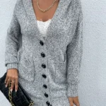 Front closed view of gray knit hooded cardigan featuring soft knit fabric, button or zip closure, relaxed fit silhouette, long sleeves, and attached hood for a cozy and stylish fall or winter layering look.