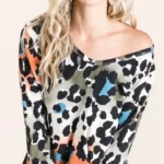 Model wearing a soft leopard print u neck top with lightweight fabric and relaxed fit, styled for casual everyday fashion.