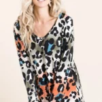 Model wearing a soft leopard print u neck top with lightweight fabric and relaxed fit, styled for casual everyday fashion.