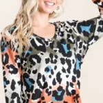 Model wearing a soft leopard print u neck top with lightweight fabric and relaxed fit, styled for casual everyday fashion.