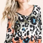 Model wearing a soft leopard print u neck top with lightweight fabric and relaxed fit, styled for casual everyday fashion.