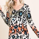 Model wearing a soft leopard print u neck top with lightweight fabric and relaxed fit, styled for casual everyday fashion.