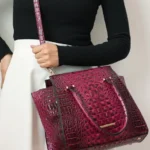 Close-up of a model wearing the MKF Collection Viridiana Croc-Embossed Tote Bag using the shoulder strap, highlighting the textured croc-embossed design, sleek faux leather finish, and stylish, hands-free carrying option.