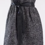 Close-up of ebony mini tweed dress midsection showing textured black tweed fabric and stylish belt detail