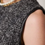 Close-up of ebony mini tweed dress showing premium black tweed texture and luxury woven fabric detail