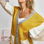 Side view of Bibi Color Block Cardigan in a relaxed fit, featuring bold color block design and soft knit fabric, styled on a model or mannequin to showcase cozy, fashion-forward layering for fall and winter.