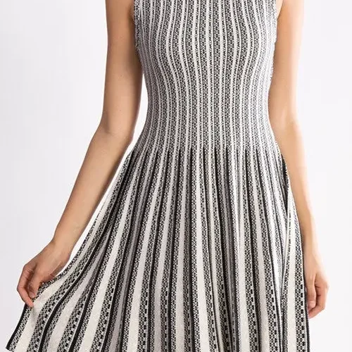 Jacquard sweater knitted dress styled on a model, featuring soft textured knit fabric, long sleeves, and elegant jacquard pattern, showcasing a cozy, relaxed-fit look perfect for fall and winter fashion.