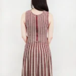 Back view of a jacquard sweater knitted dress, showcasing the textured knit fabric, elegant jacquard pattern, and relaxed-fit design for a cozy and stylish fall or winter look.
