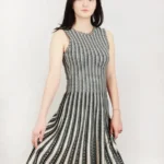 Jacquard sweater knitted dress styled on a model, featuring soft textured knit fabric, long sleeves, and elegant jacquard pattern, showcasing a cozy, relaxed-fit look perfect for fall and winter fashion.