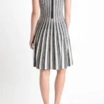 Back view of a jacquard sweater knitted dress, showcasing the textured knit fabric, elegant jacquard pattern, and relaxed-fit design for a cozy and stylish fall or winter look.