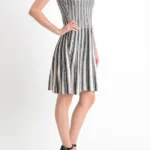 Side view of a jacquard sweater knitted dress, highlighting the textured knit fabric, elegant jacquard pattern, and relaxed-fit silhouette for a cozy and fashion-forward fall or winter look.
