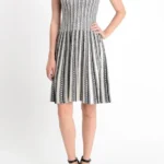 Jacquard sweater knitted dress styled on a model, featuring soft textured knit fabric, long sleeves, and elegant jacquard pattern, showcasing a cozy, relaxed-fit look perfect for fall and winter fashion.