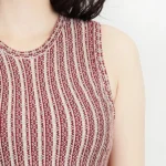 Close-up of the upper part of a jacquard sweater knitted dress, highlighting the textured knit fabric, elegant jacquard pattern, and cozy long-sleeve design for a chic, fall and winter-ready look.