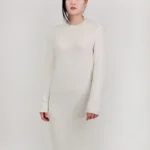 Loose fit textured midi sweater dress in soft knit fabric, styled on a mannequin or model, showcasing cozy, oversized design and chic midi length perfect for fall and winter layering.