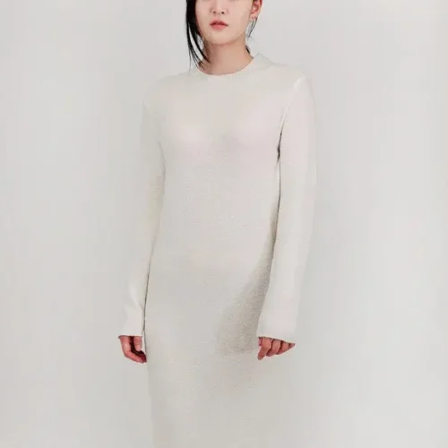Loose fit textured midi sweater dress in soft knit fabric, styled on a mannequin or model, showcasing cozy, oversized design and chic midi length perfect for fall and winter layering.