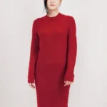 Loose fit textured midi sweater dress in soft knit fabric, styled on a mannequin or model, showcasing cozy, oversized design and chic midi length perfect for fall and winter layering.