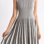 Jacquard sweater knitted dress styled on a model, featuring soft textured knit fabric, long sleeves, and elegant jacquard pattern, showcasing a cozy, relaxed-fit look perfect for fall and winter fashion.