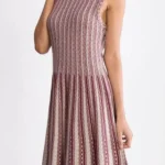 Jacquard sweater knitted dress styled on a model, featuring soft textured knit fabric, long sleeves, and elegant jacquard pattern, showcasing a cozy, relaxed-fit look perfect for fall and winter fashion.