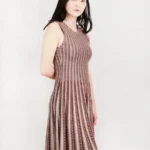 Side view of a jacquard sweater knitted dress, highlighting the textured knit fabric, elegant jacquard pattern, and relaxed-fit silhouette for a cozy and fashion-forward fall or winter look.