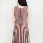 Back view of a jacquard sweater knitted dress, showcasing the textured knit fabric, elegant jacquard pattern, and relaxed-fit design for a cozy and stylish fall or winter look.
