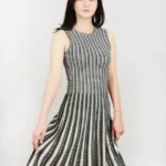 Jacquard sweater knitted dress styled on a model, featuring soft textured knit fabric, long sleeves, and elegant jacquard pattern, showcasing a cozy, relaxed-fit look perfect for fall and winter fashion.