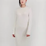 Loose fit textured midi sweater dress in soft knit fabric, styled on a mannequin or model, showcasing cozy, oversized design and chic midi length perfect for fall and winter layering.