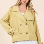 Detailed view of double breasted buttons and lapel on women’s mittoshop trench coat jacket